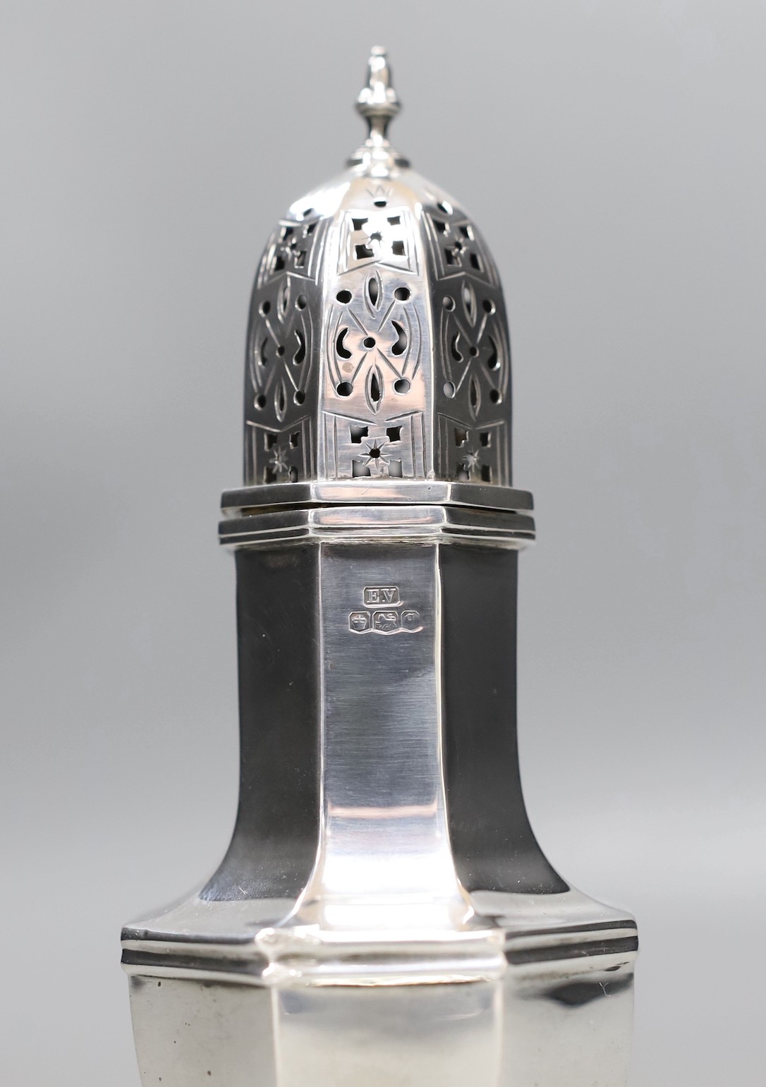 A George V silver octagonal silver sugar caster, Viners Ltd, Sheffield, 1933, 17.8cm and a Royal Jubilee 1977 commemorative letter opener, 17.1cm, 7.2oz.